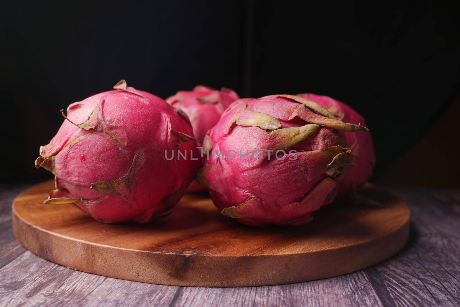 slice of dragon fruit on a chopping board.,