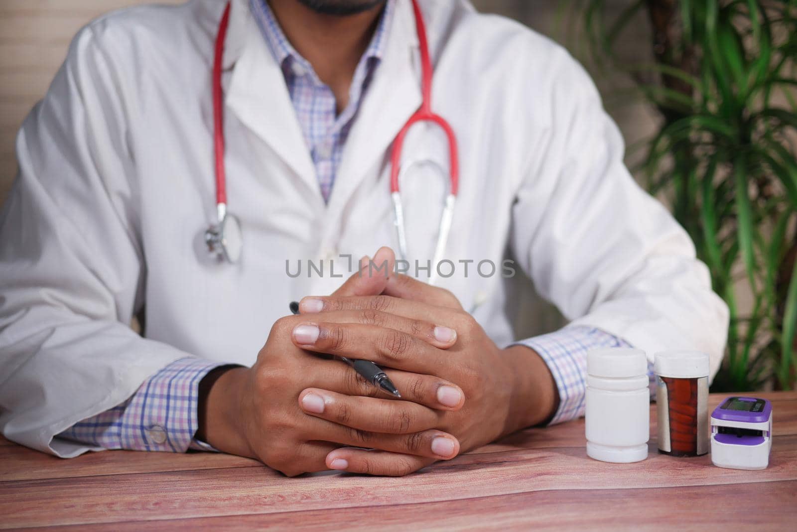 a nervous young doctor's hand on table white sited by towfiq007