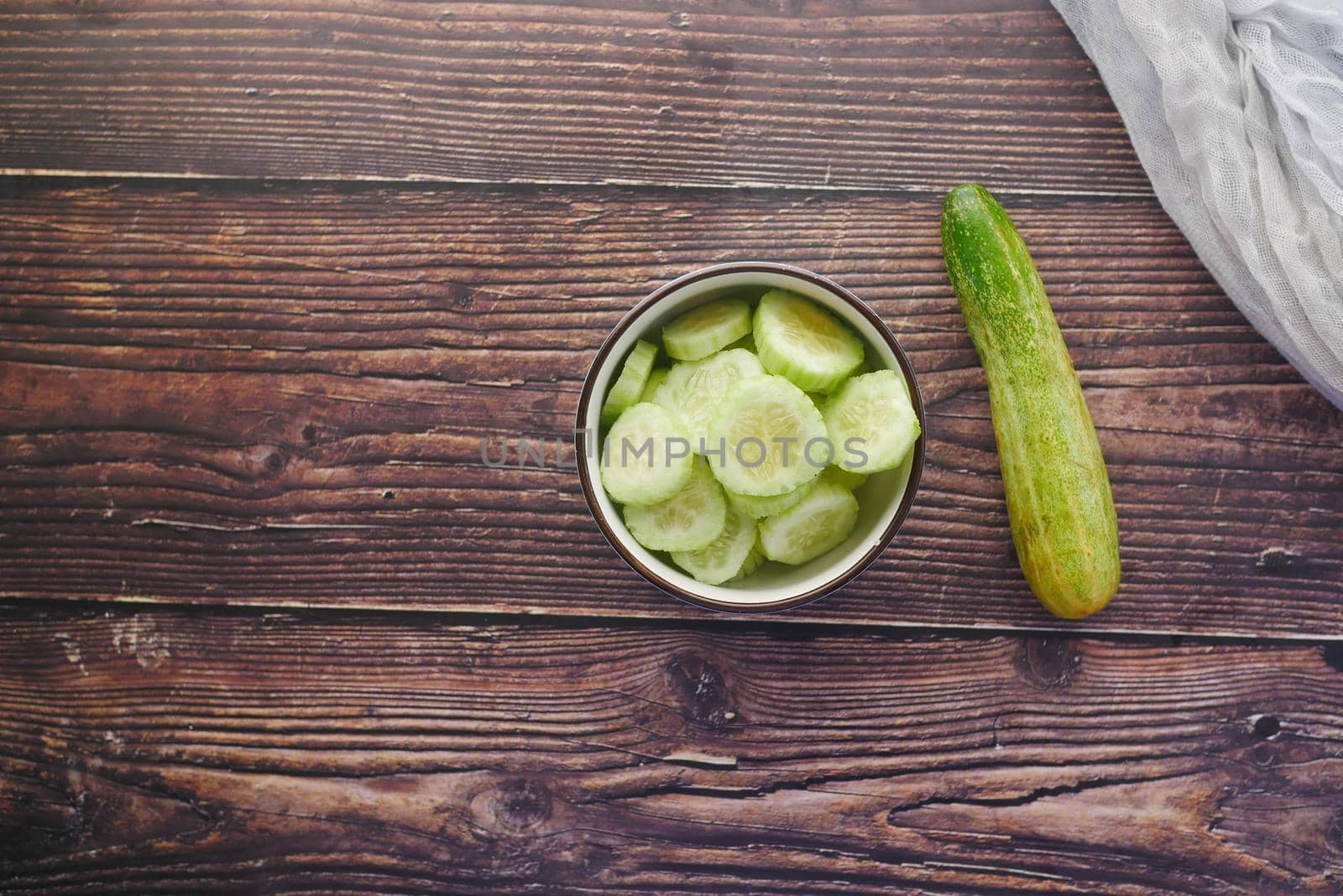 close up of slice of cucumber in a bowl on table .