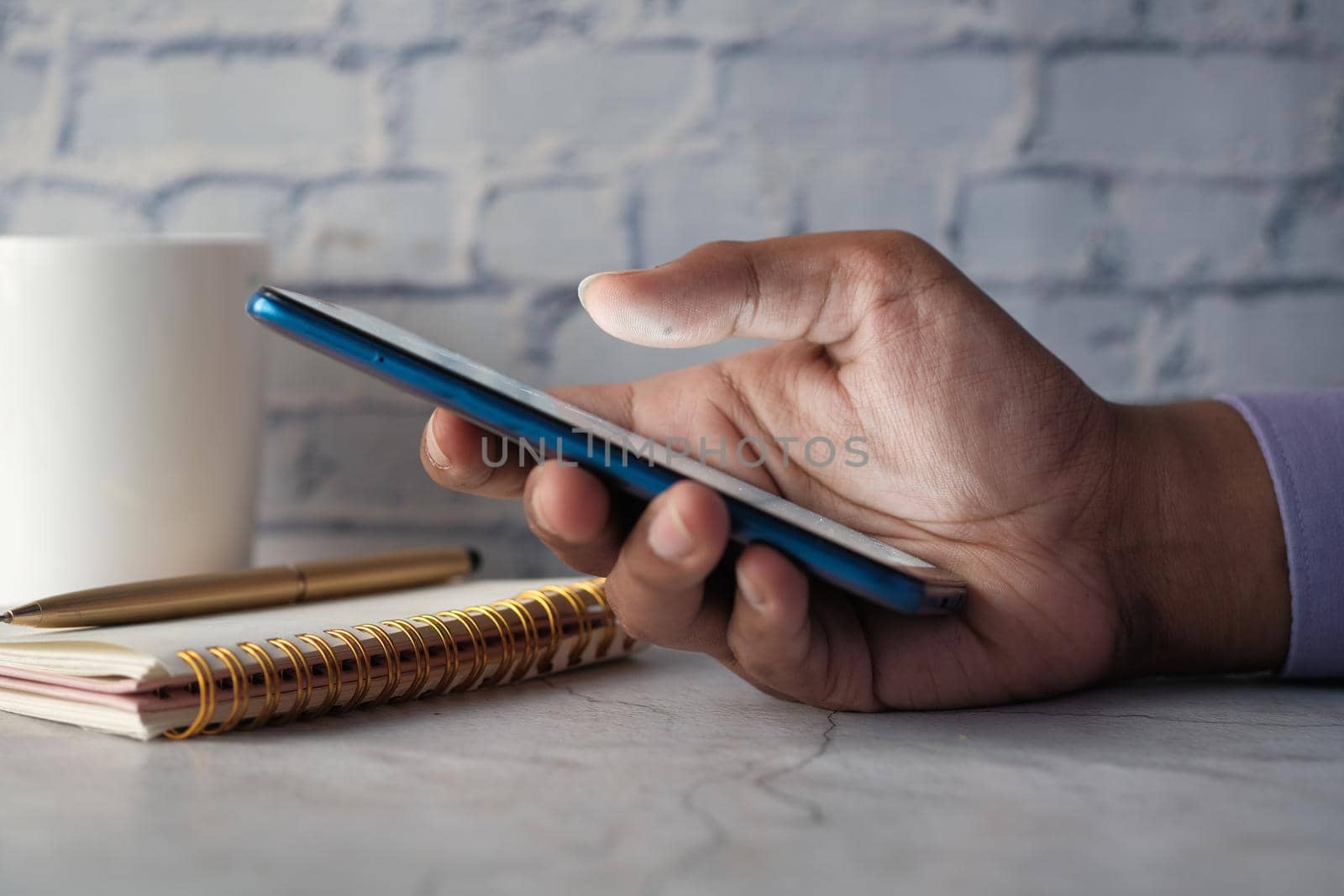 Close up of young man hand using smart phone