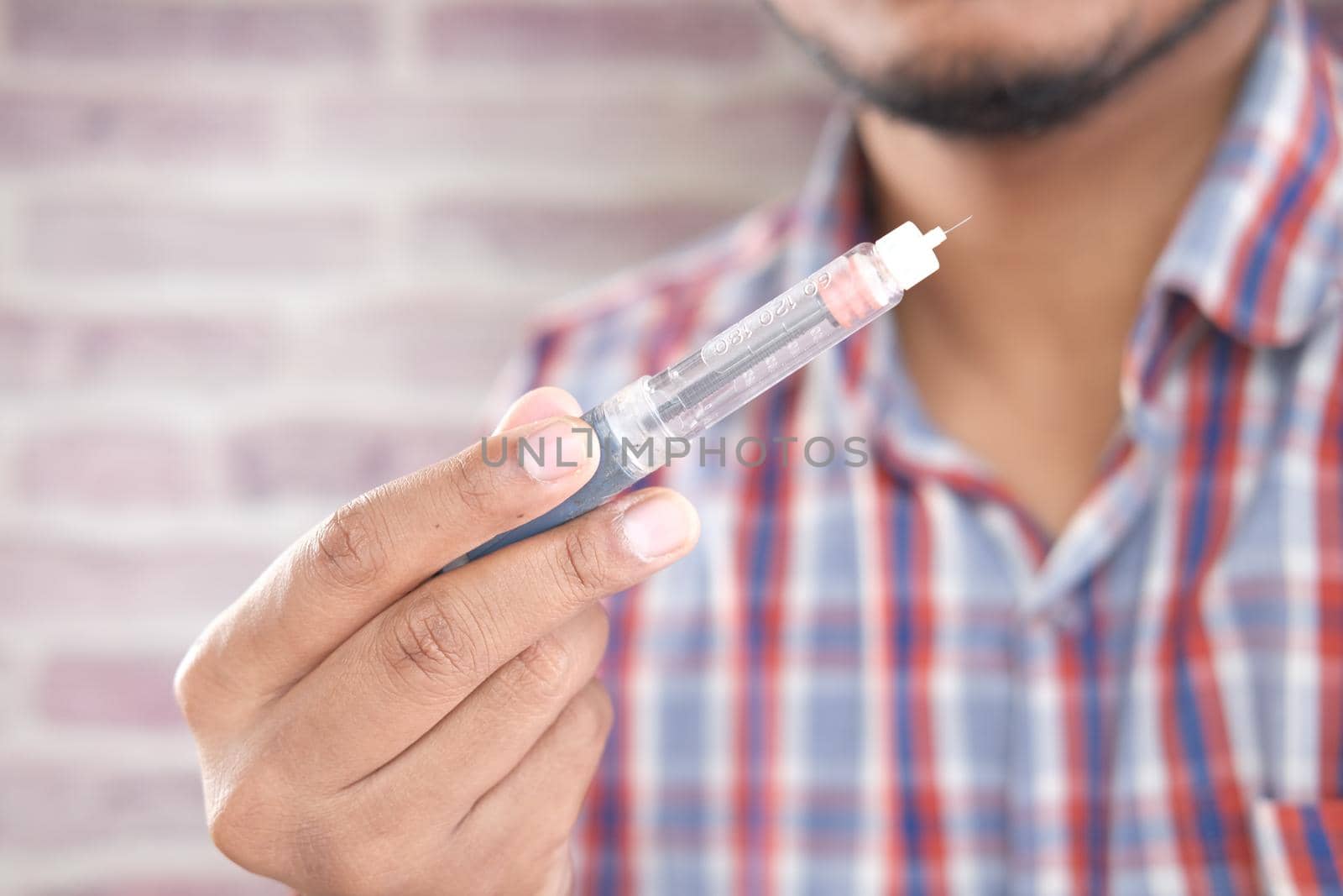 hand holding Insulin pens with copy space, Top down.