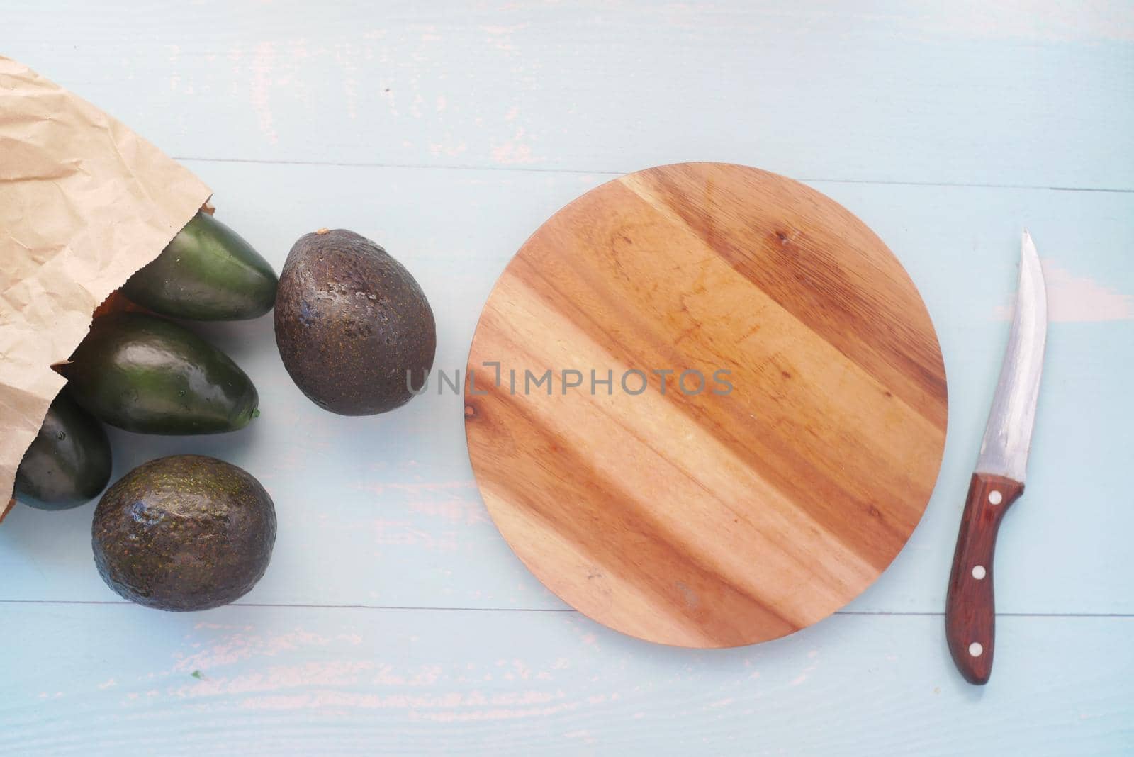 top view of slice of avocado on wooden table ,