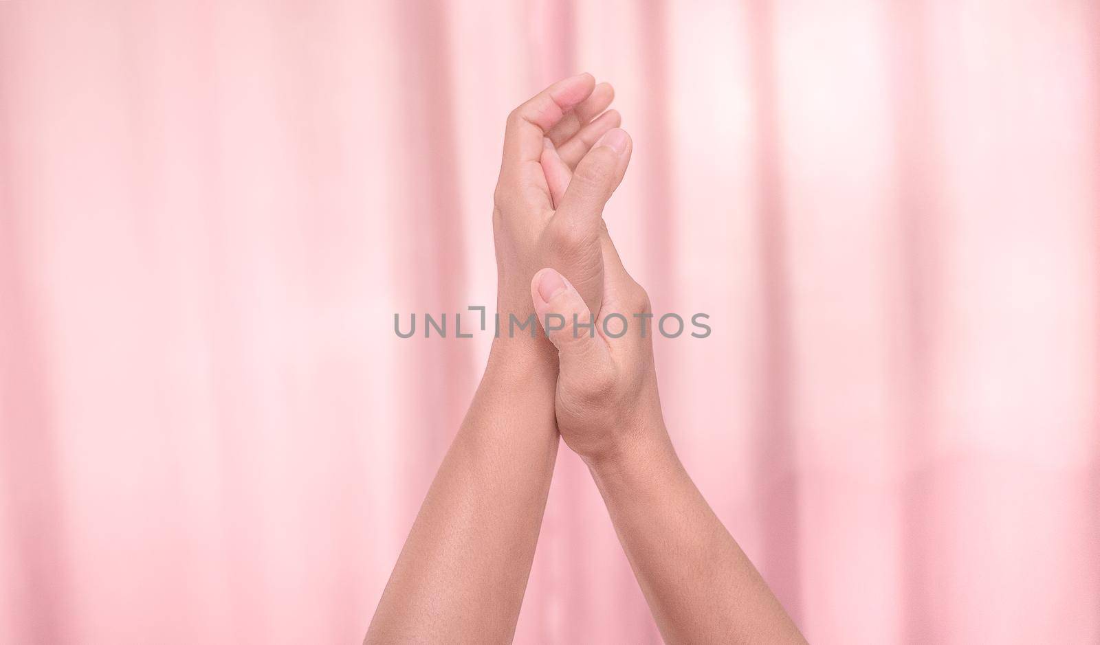 Hands applauding isolated on pink background. Isolated female hands applauding symbol of appreciation. Sign language. by TEERASAK