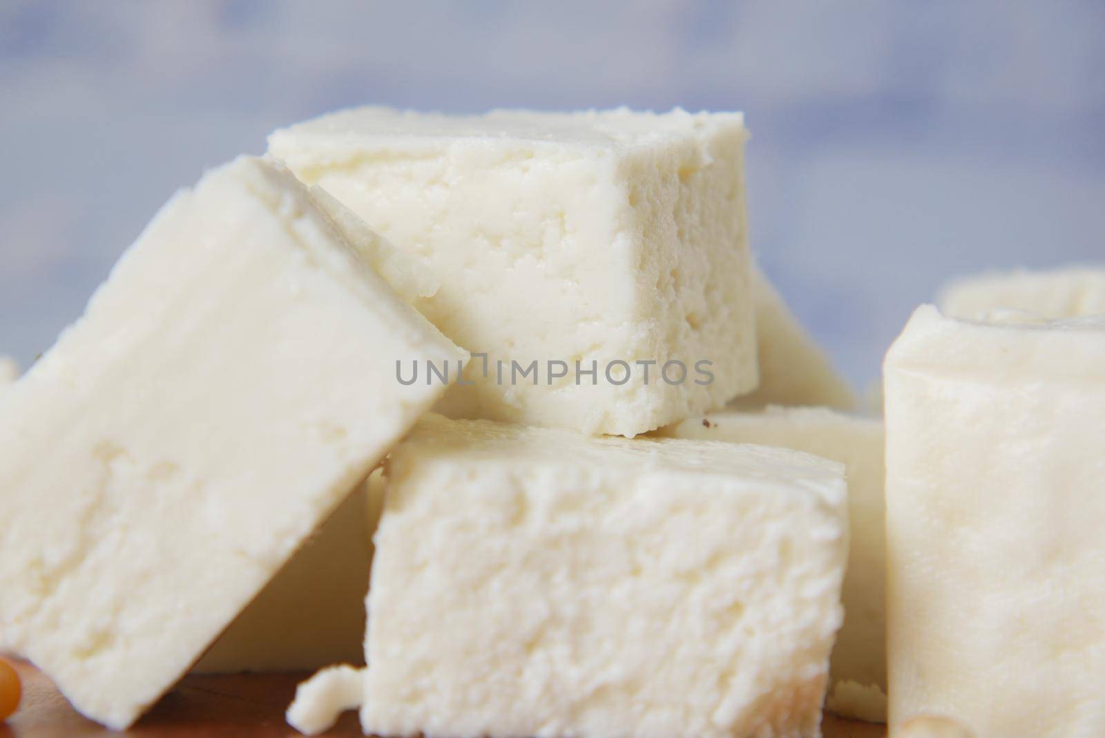 close up of cube shape fresh cheese in a bowl ,