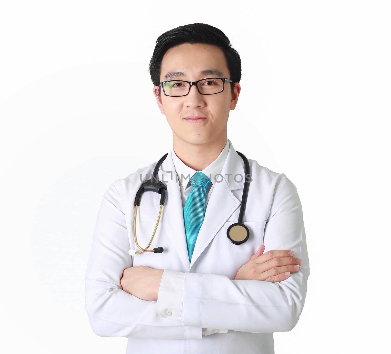 Doctor posing with arms crossed, medical staff working on blurry background. by jayzynism