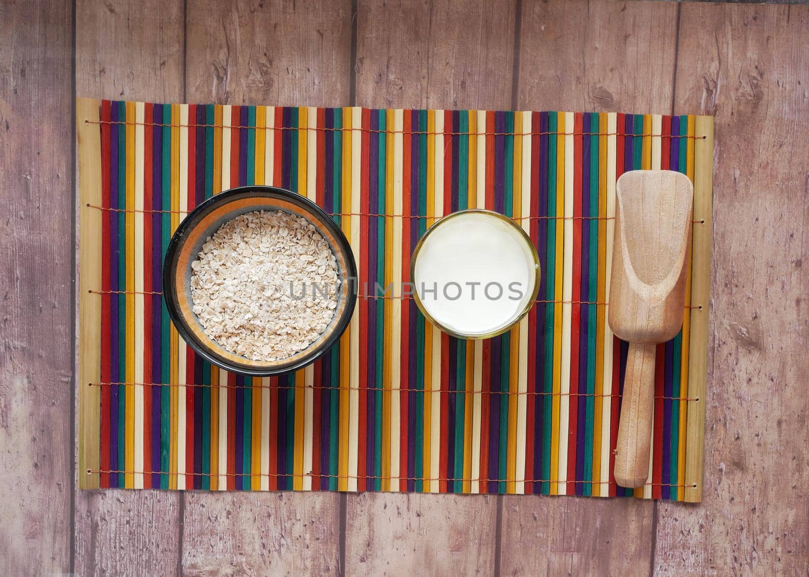 uncooked oats flakes black background, top down.