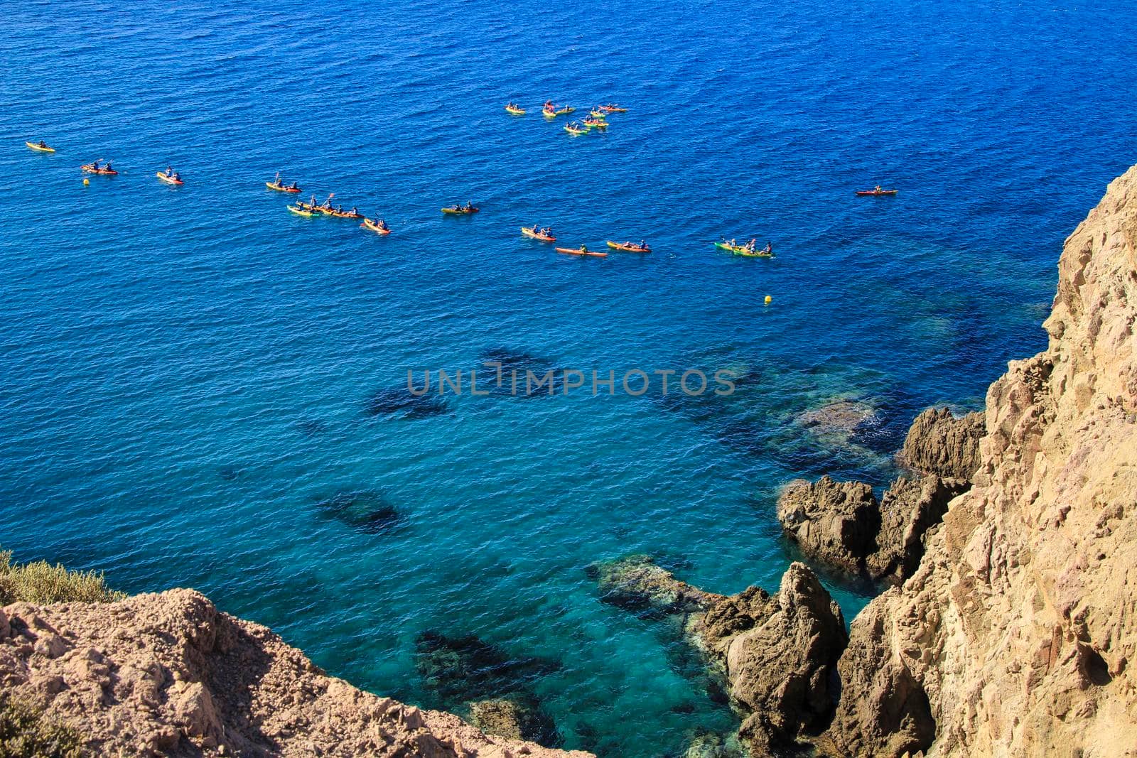 People practicing canoeing in the Reef of the Sirens in Cabo de Gata, Almeria, Spain.