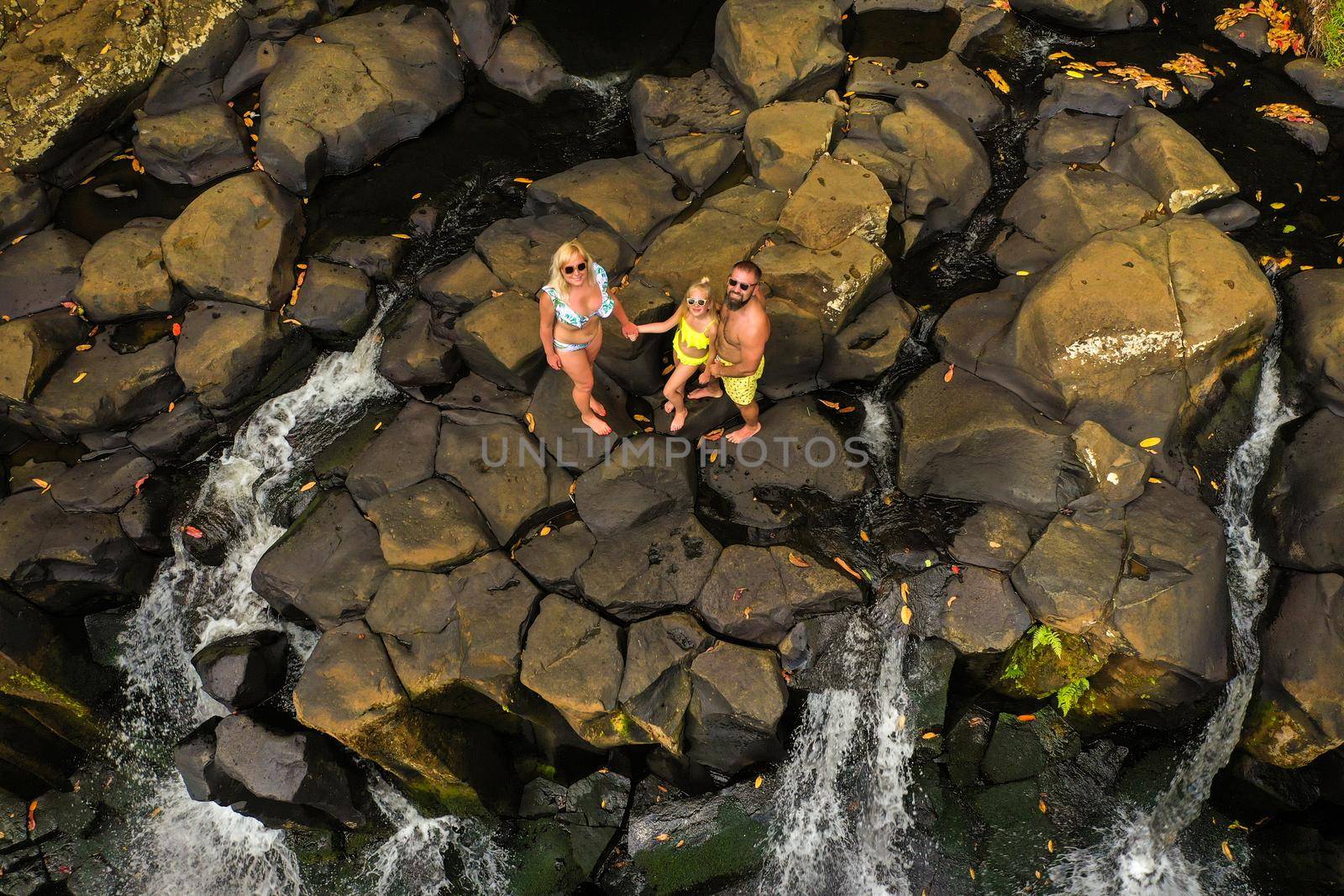 Family on the background of the Rochester waterfall on the island of Mauritius from a height.Waterfall in the jungle of the tropical island of Mauritius by Lobachad