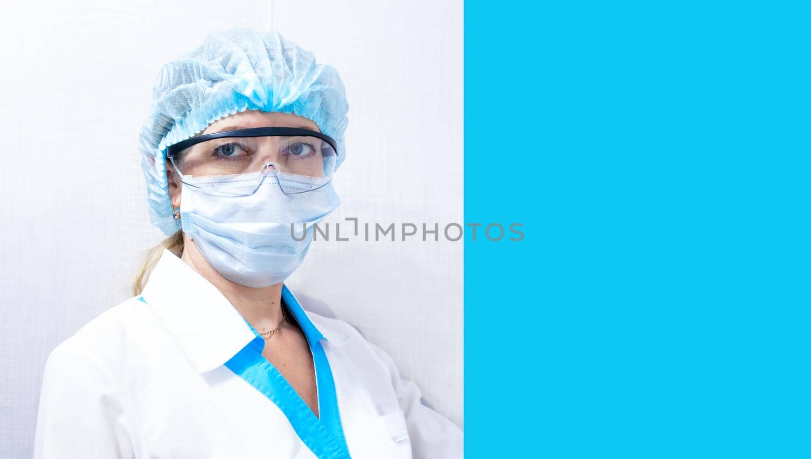 medical worker in personal protective equipment, blue background on the right by levnat09