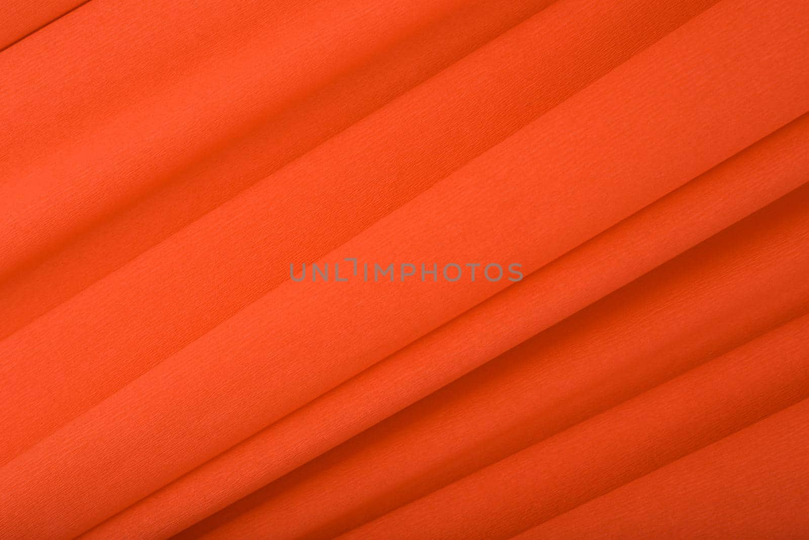 Abstract orange background with diagonal lines. Orange textured background with waves made of corrugated paper. Concept of template for advertising or banner with copy space