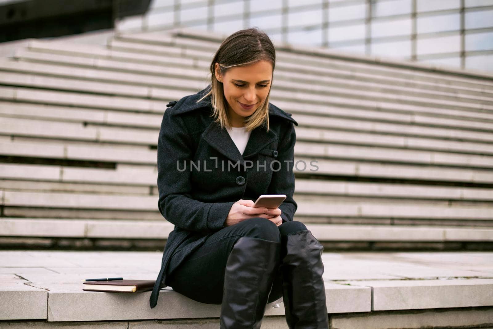 Businesswoman using mobile phone by Bazdar
