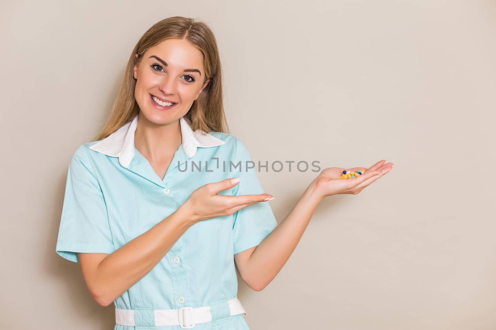 Image of medical nurse showing  pills.