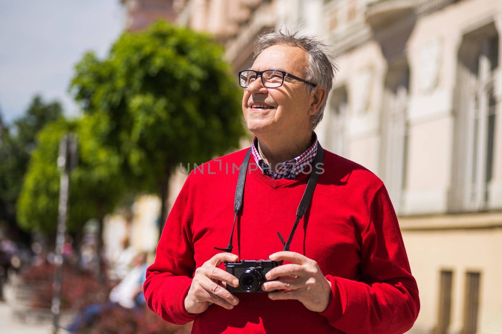 Senior man tourist  photographing at the city by Bazdar