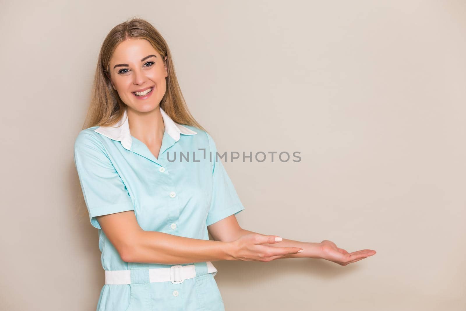 Image of medical nurse showing welcome gesture.
