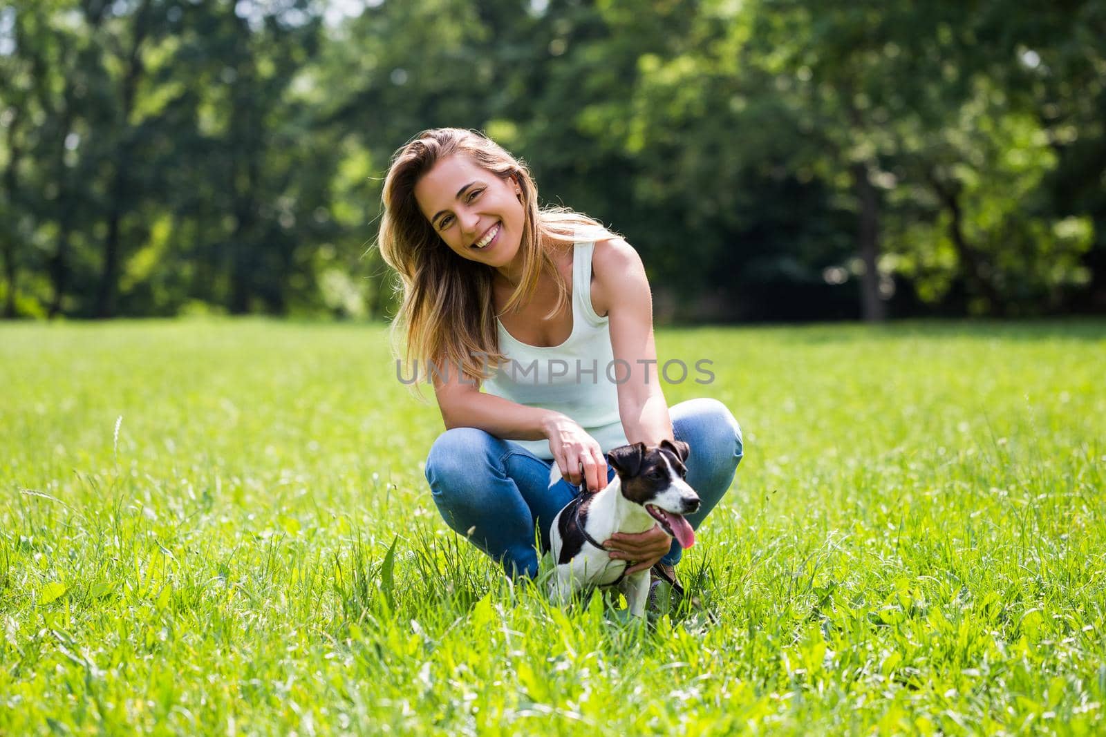 Woman spending time in the nature with her  dog Jack Russell Terrier by Bazdar