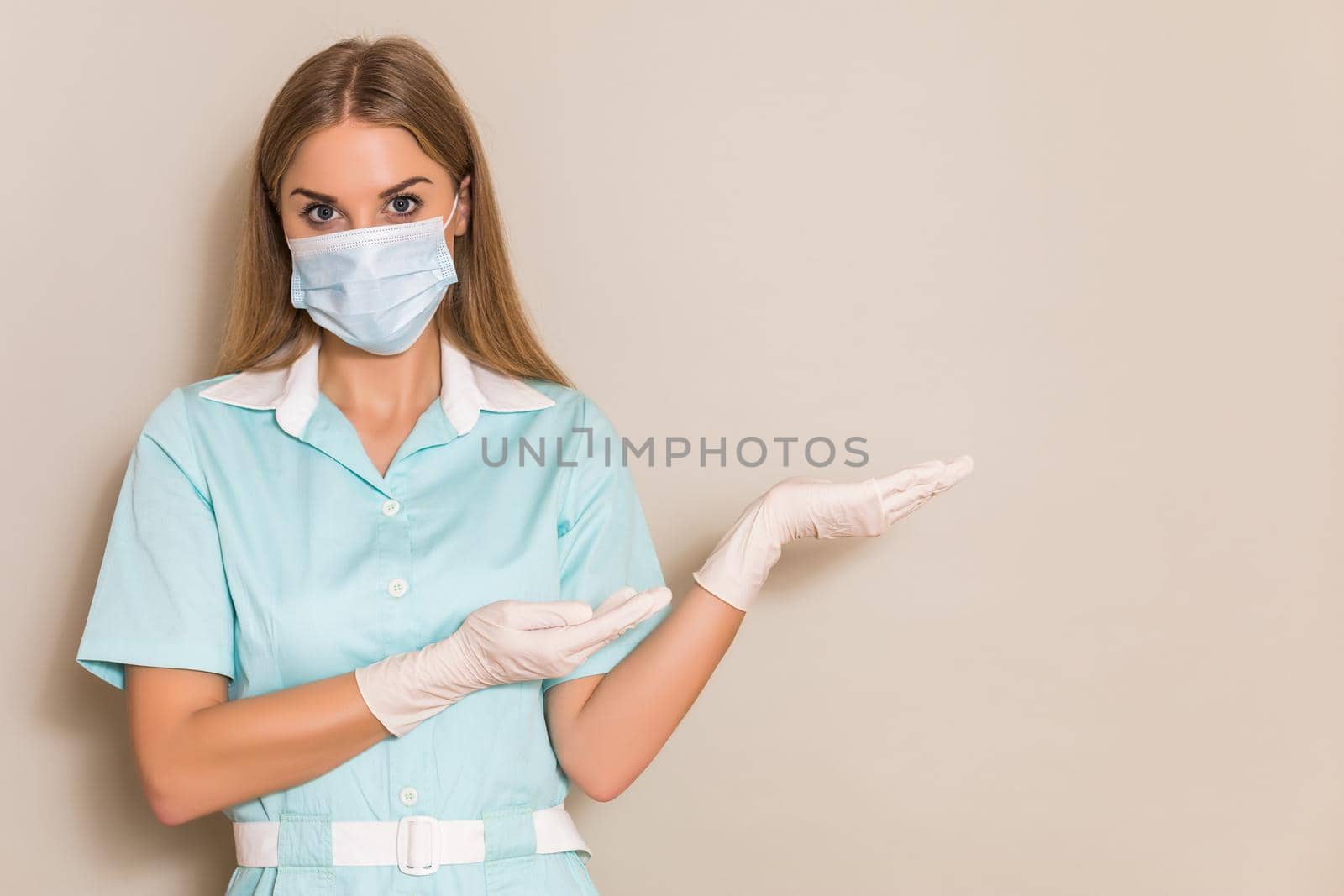 Portrait of nurse with protective mask gesturing.