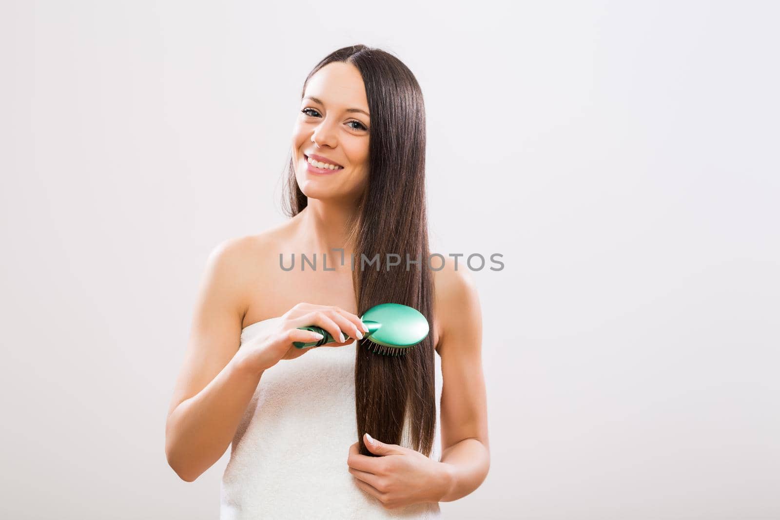Woman brushing her long hair by Bazdar