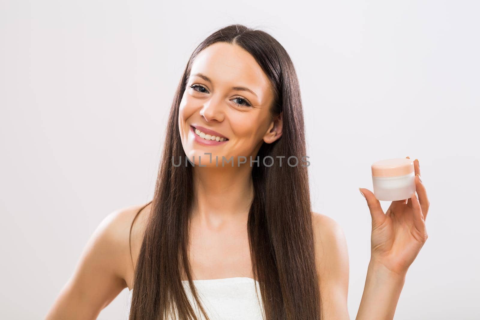 Woman showing beauty product by Bazdar