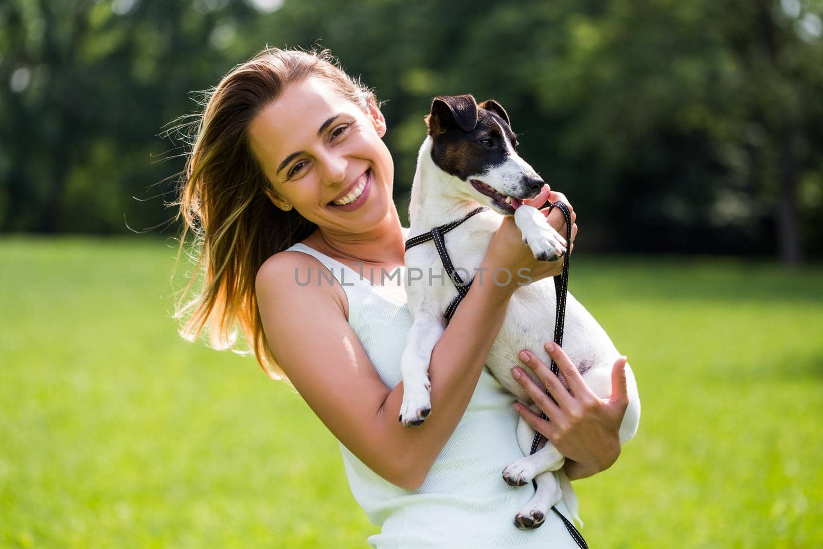 Woman  spending time in the nature with her  dog Jack Russell Terrier by Bazdar