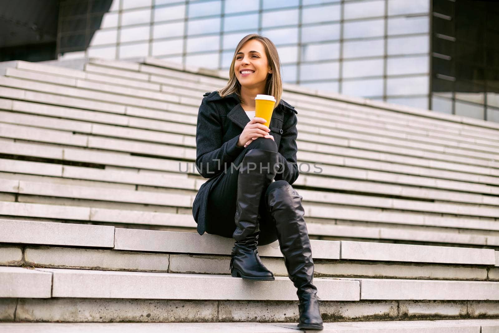 Businesswoman enjoys resting and drinking coffee.