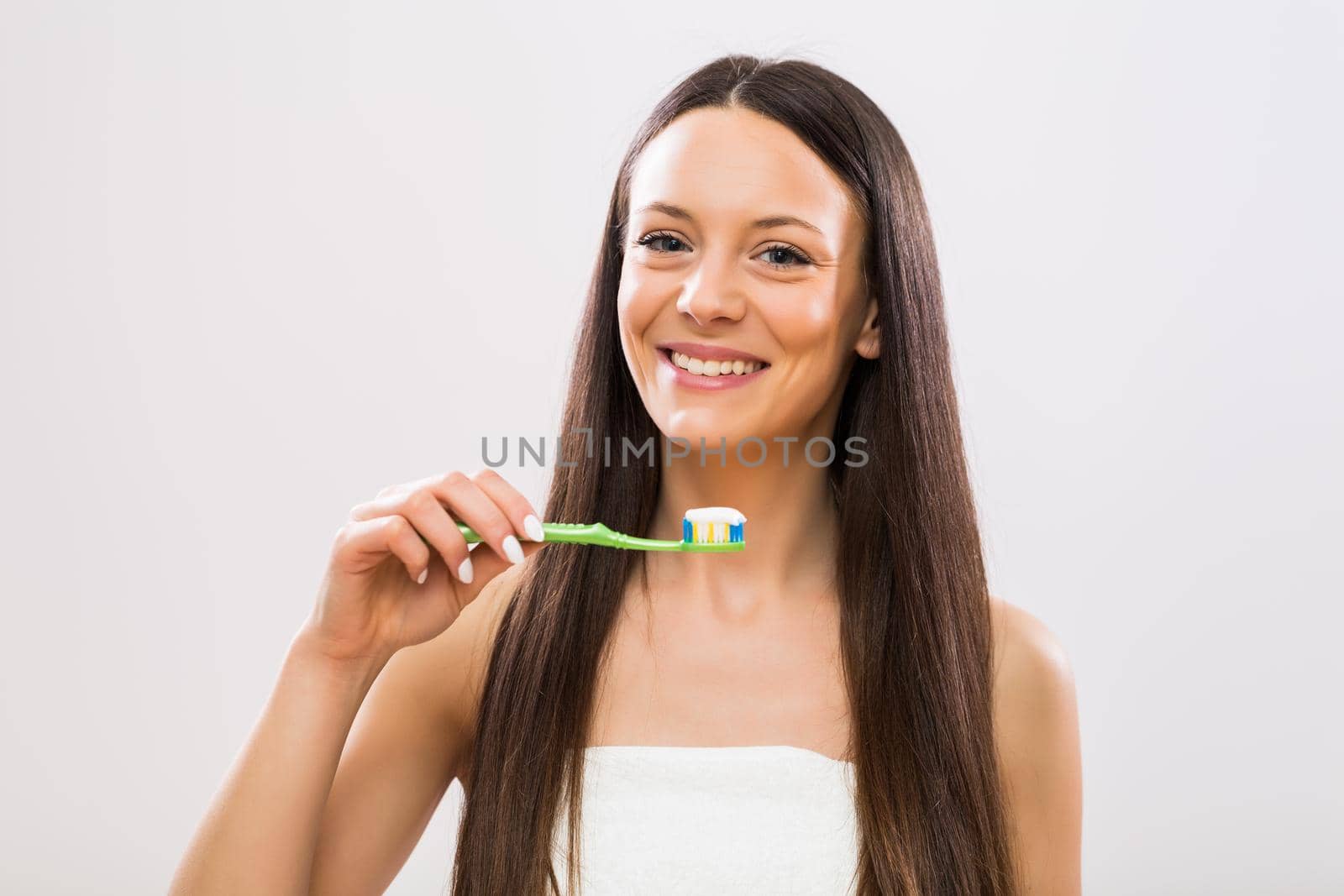 Portrait of woman holding toothbrush by Bazdar