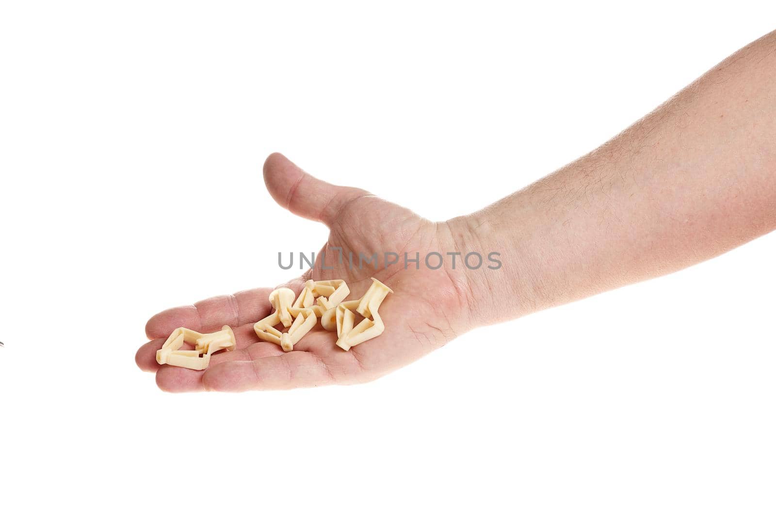 Hand holds a plastic dowel for screws on a white background, a template for designers.