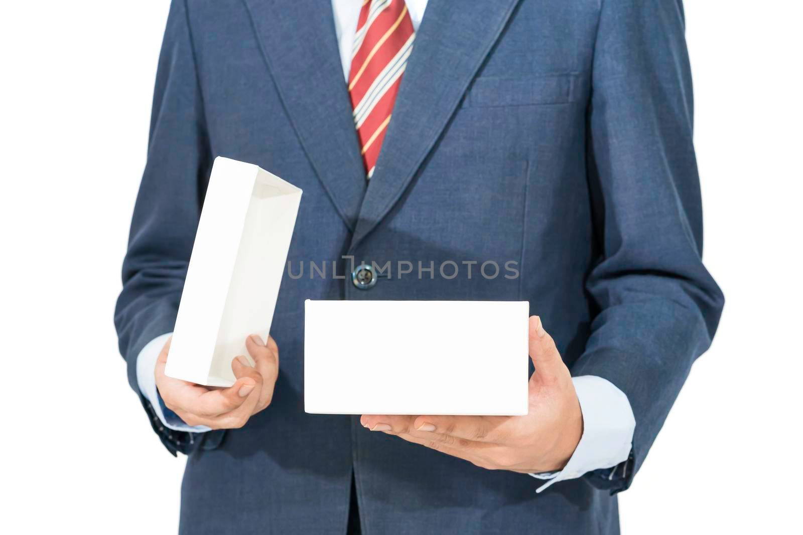 Close up of man in blue suit opening a white gift box isolated on white background with clipping path