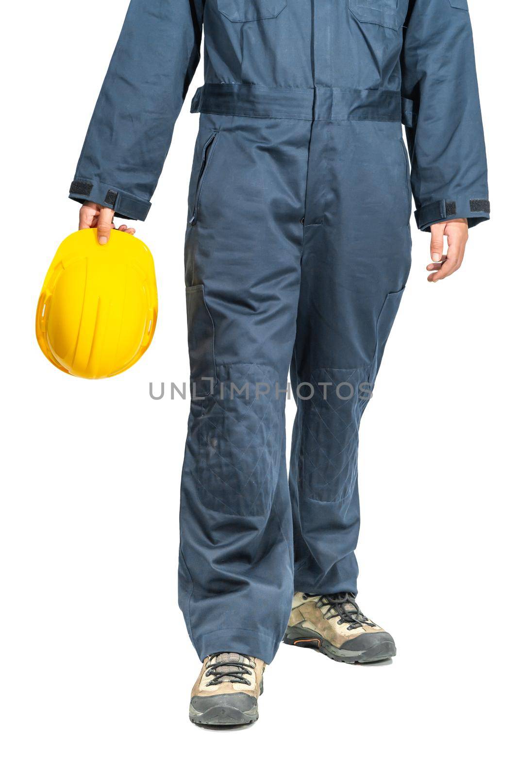 Cloes up Worker standing in blue coverall holding yellow hardhat isolated on white background