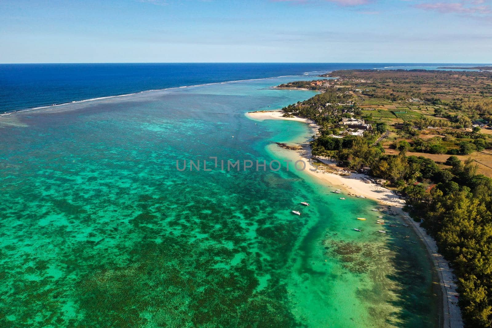 View from the height of the east coast of the island of Mauritius. Flying over the turquoise lagoon of the island of Mauritius in the area of Bel Mare