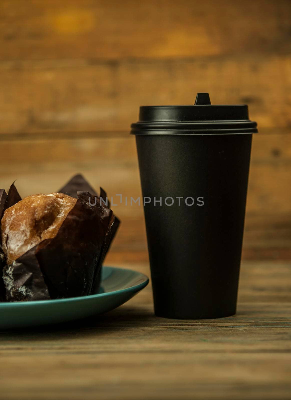 Homemade chocolate and vanilla cupcakes with paper disposable coffee cup on a wooden table, sprinkled with powdered sugar. Breakfast by inxti