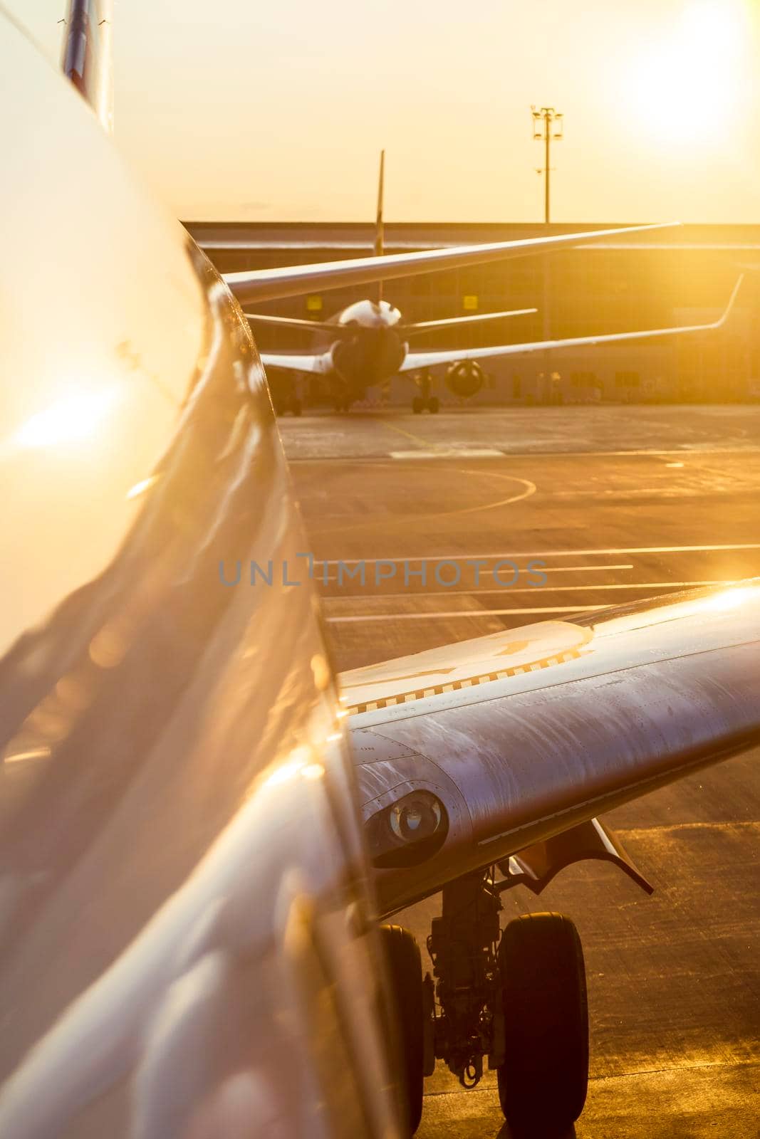 Close-up view of the plane on the runway, airport at sunset