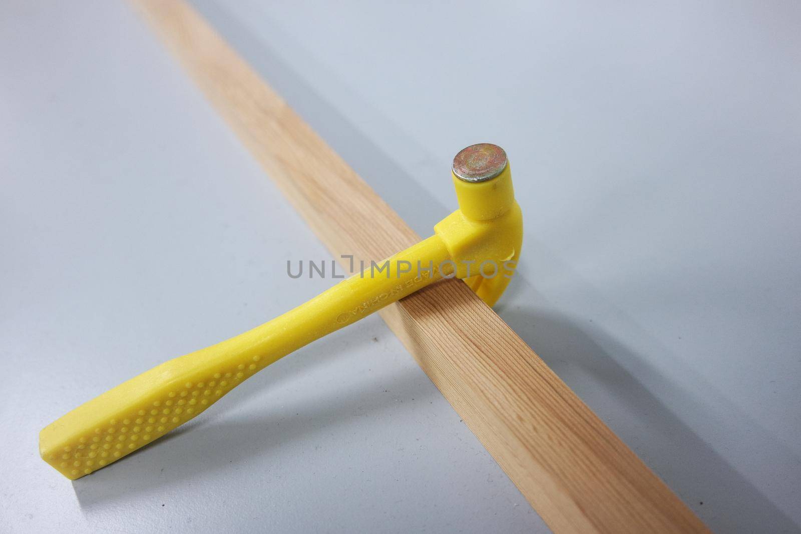 Selective focused, closeup view of toy hammer made from plastic by Photochowk
