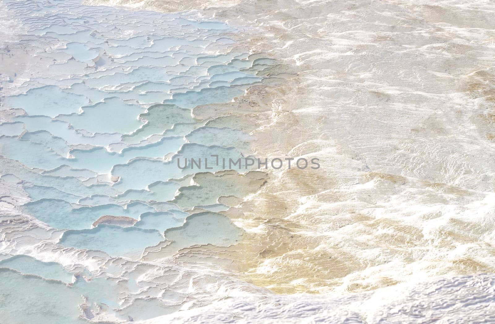 Texture with abstract pattern in pastel colors. Pamukkale calcium travertine in Turkey, top view.