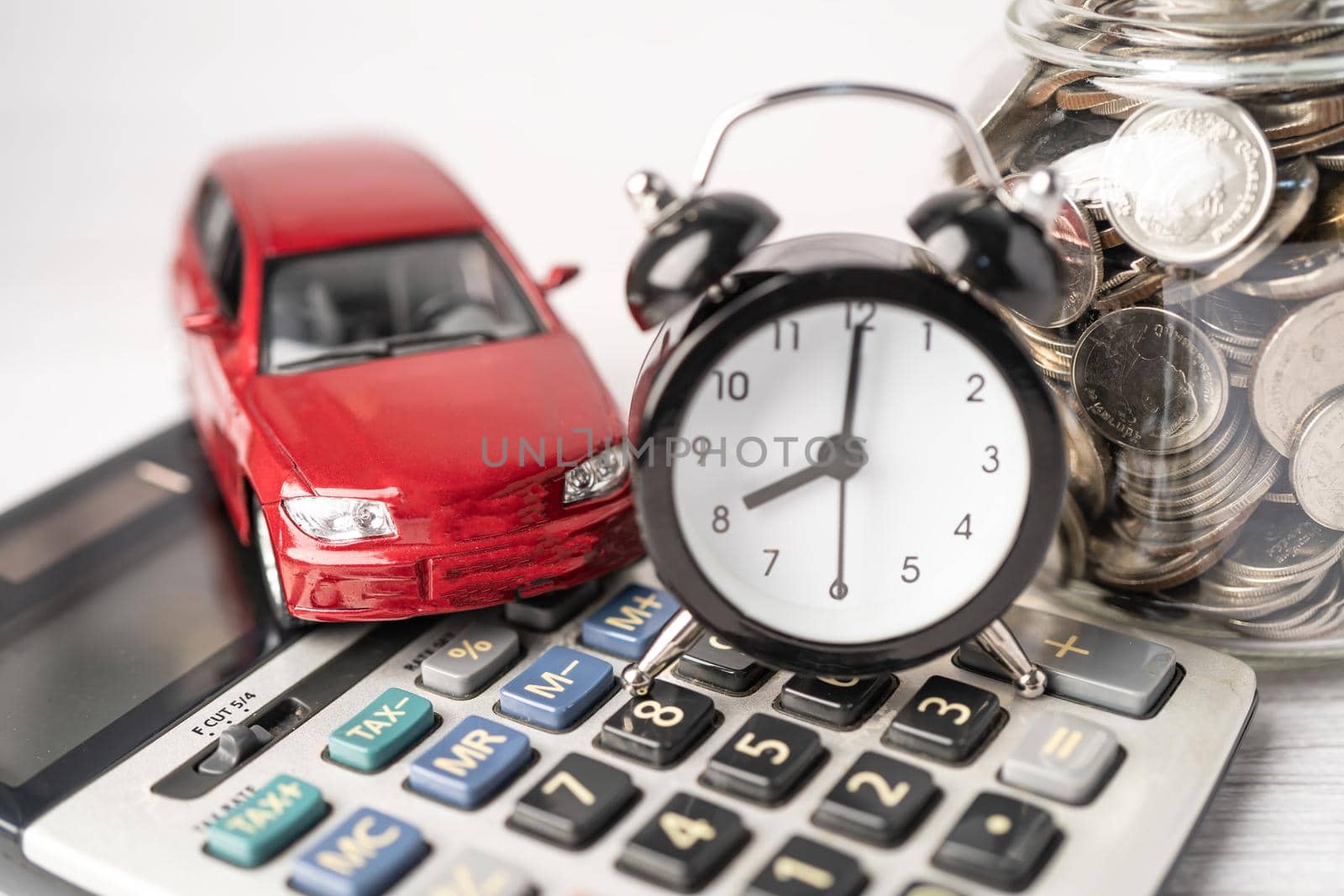 Car and alarm clock on coins, Car loan, Finance, saving money, insurance and leasing time concepts.