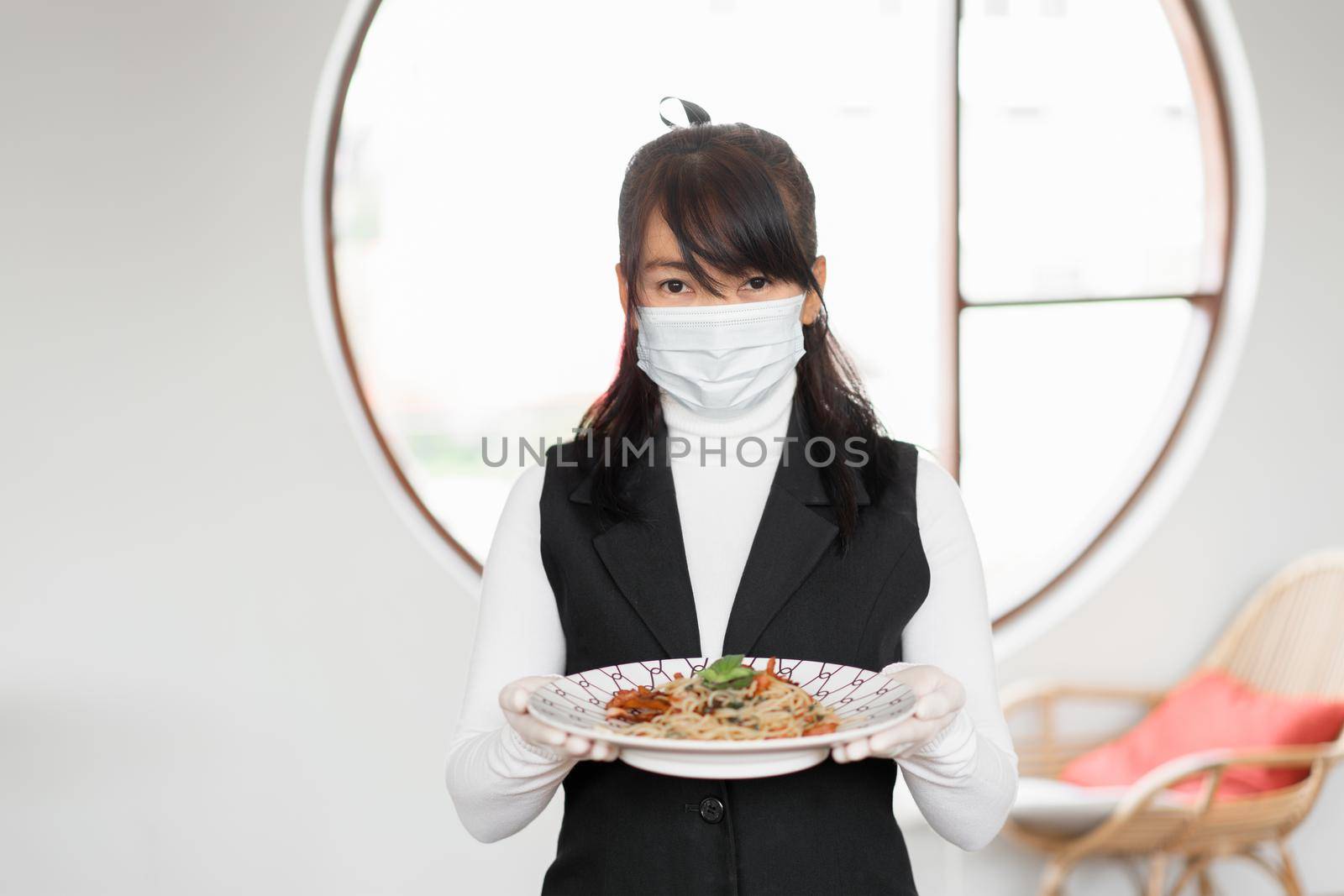 Woman waitress with face mask for working