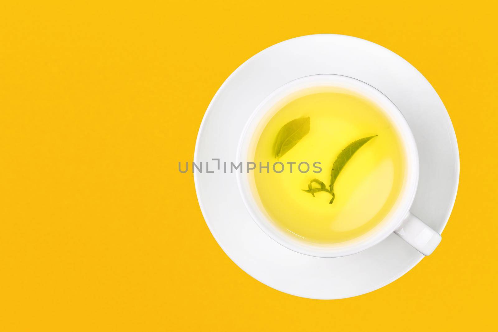 Cup of green oolong tea over yellow by BreakingTheWalls