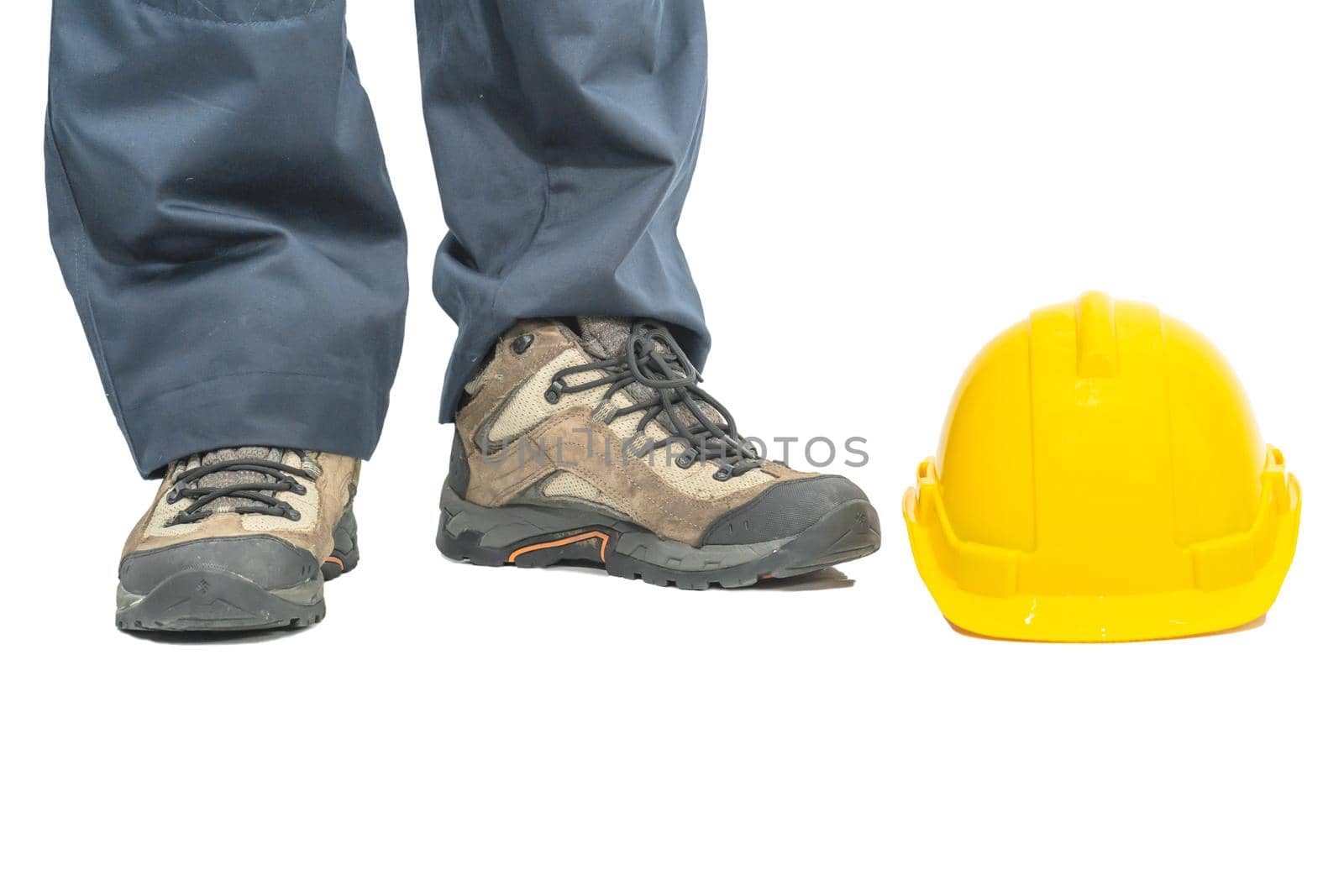 Cloes up Worker standing in blue coverall and yellow hardhat on white background
