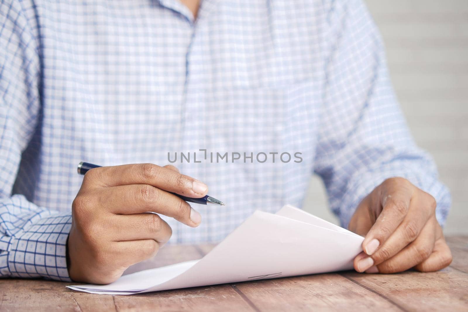 Close up of man hand writing on notepad