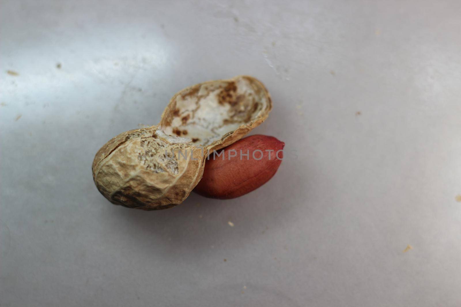Unpeeled peanut with shells. Food background of peanuts