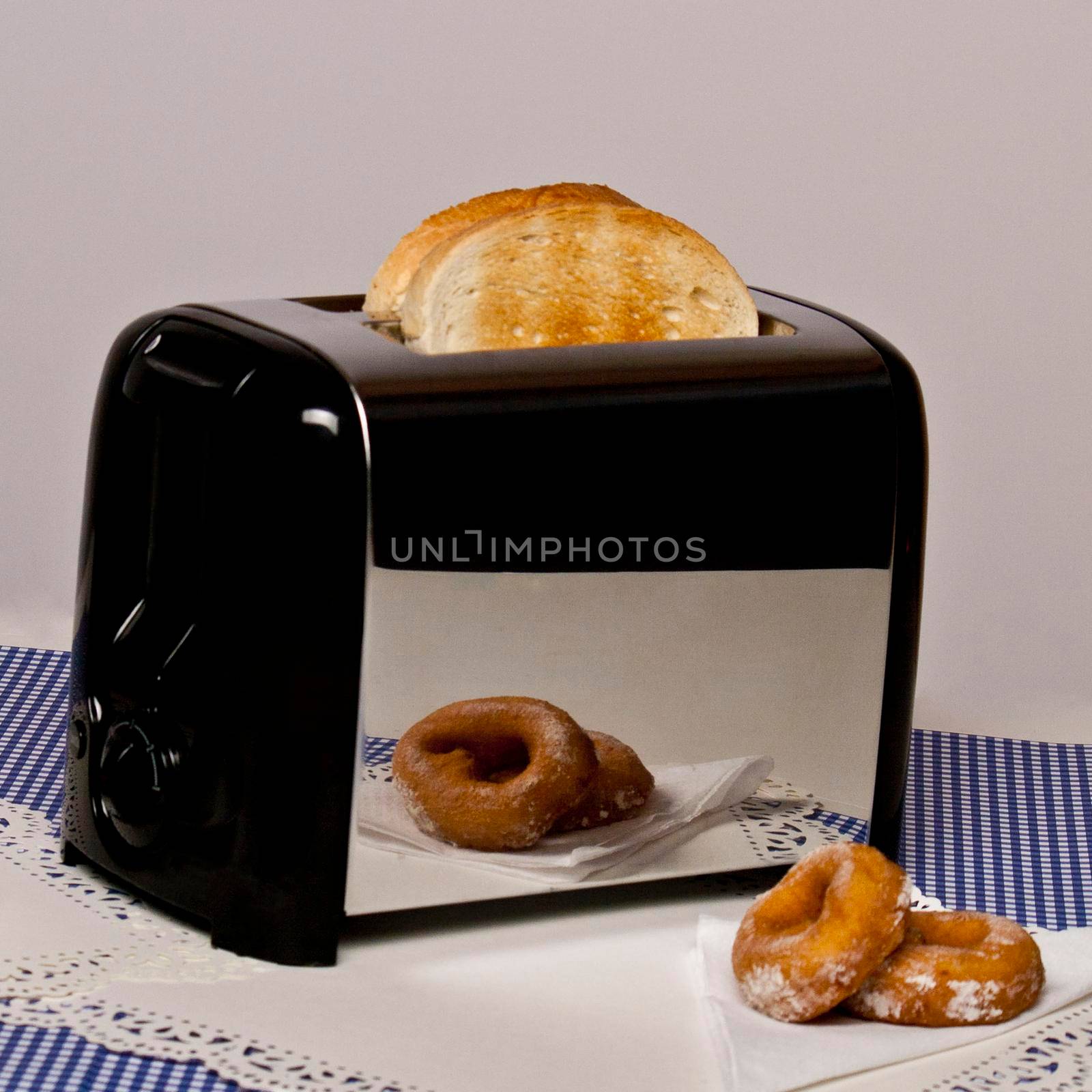 Conceptual image of toaster with bread popping up pieces of toasted bread laying out on the table morning breakfast delicious warm homey