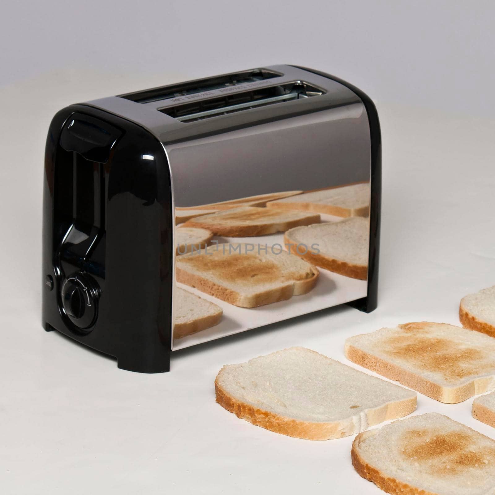 Conceptual image of toaster with bread popping up pieces of toasted bread laying out on the table morning breakfast delicious warm homey
