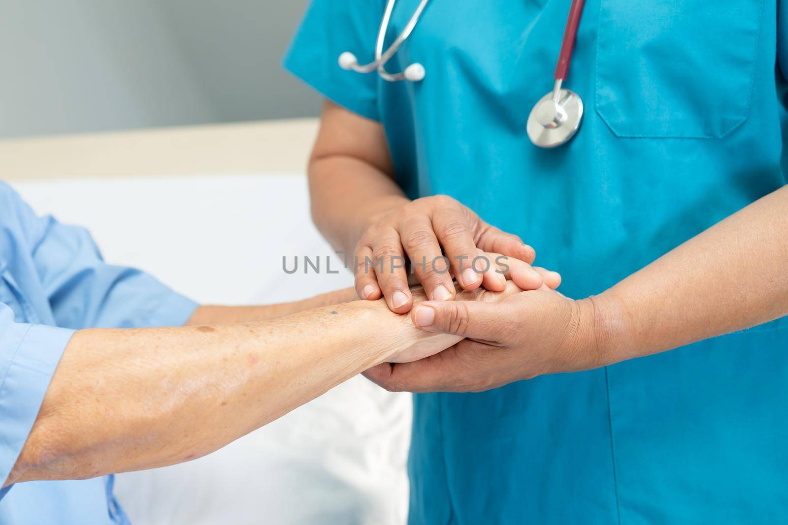 Holding hands Asian senior or elderly old lady woman patient with love, care, encourage and empathy at nursing hospital ward, healthy strong medical concept by pamai