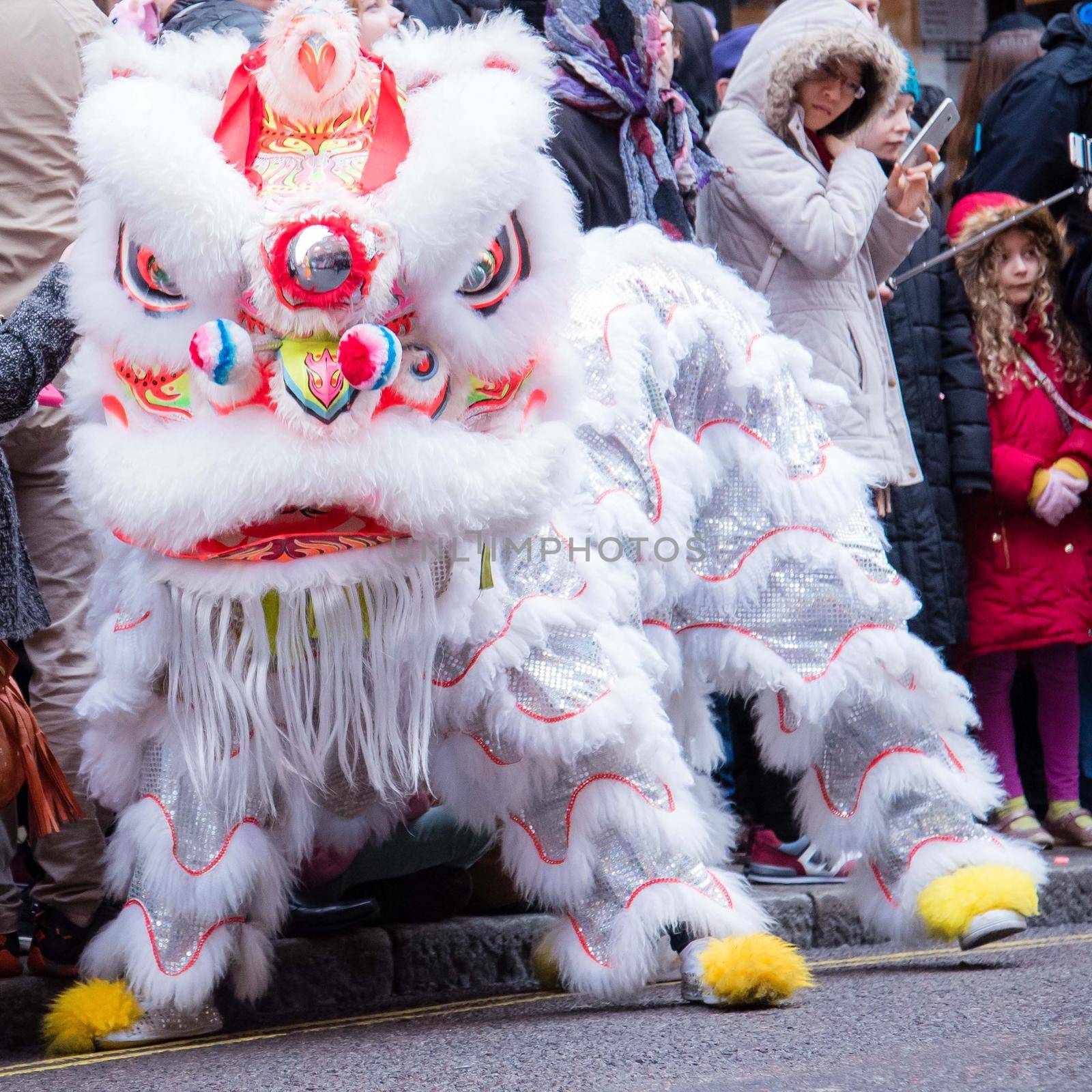 London, UK - January 29, 2017: Chinese New Year celebration parade with detail photo of the iconic white lion in a power pose.