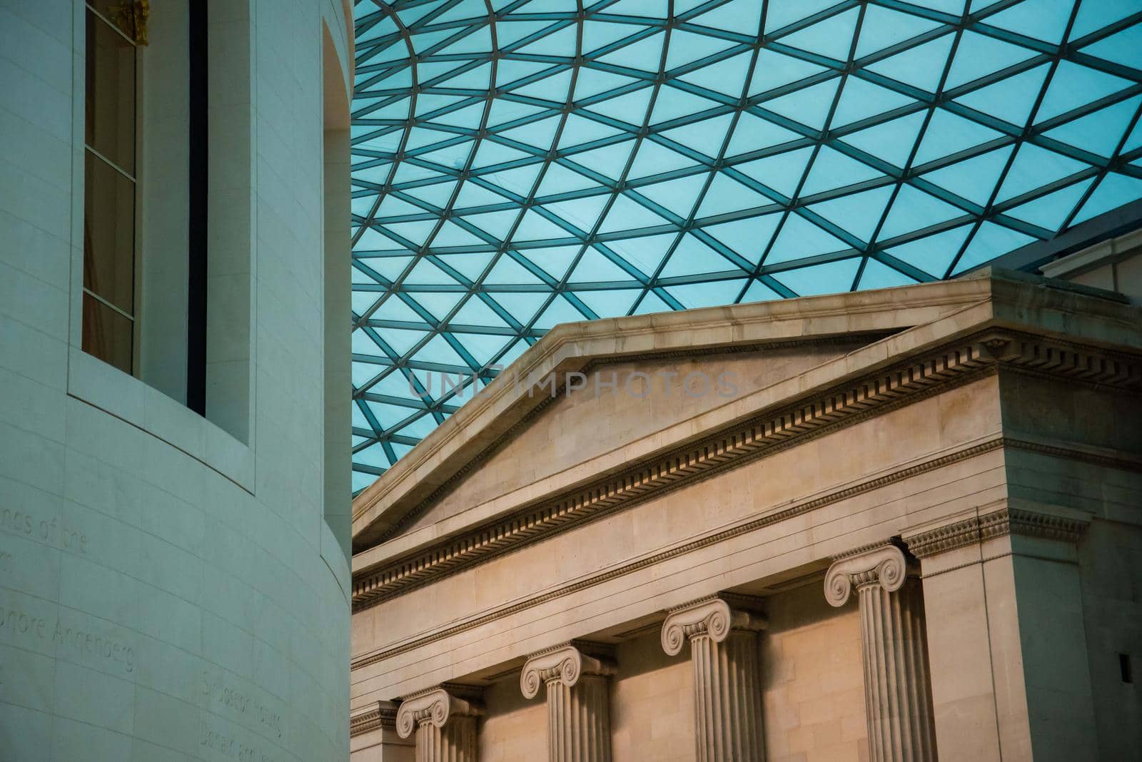 The British Museum futuristic glass ceiling roof of the Great Court juxtaposed with pillars and other architectural shapes. Unique perspective by jyurinko