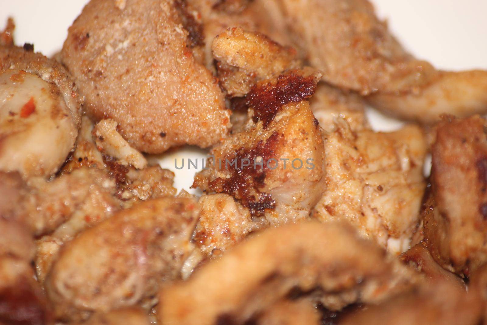 Macro closeup with selective focus on grilled chicken meat steaks. by Photochowk