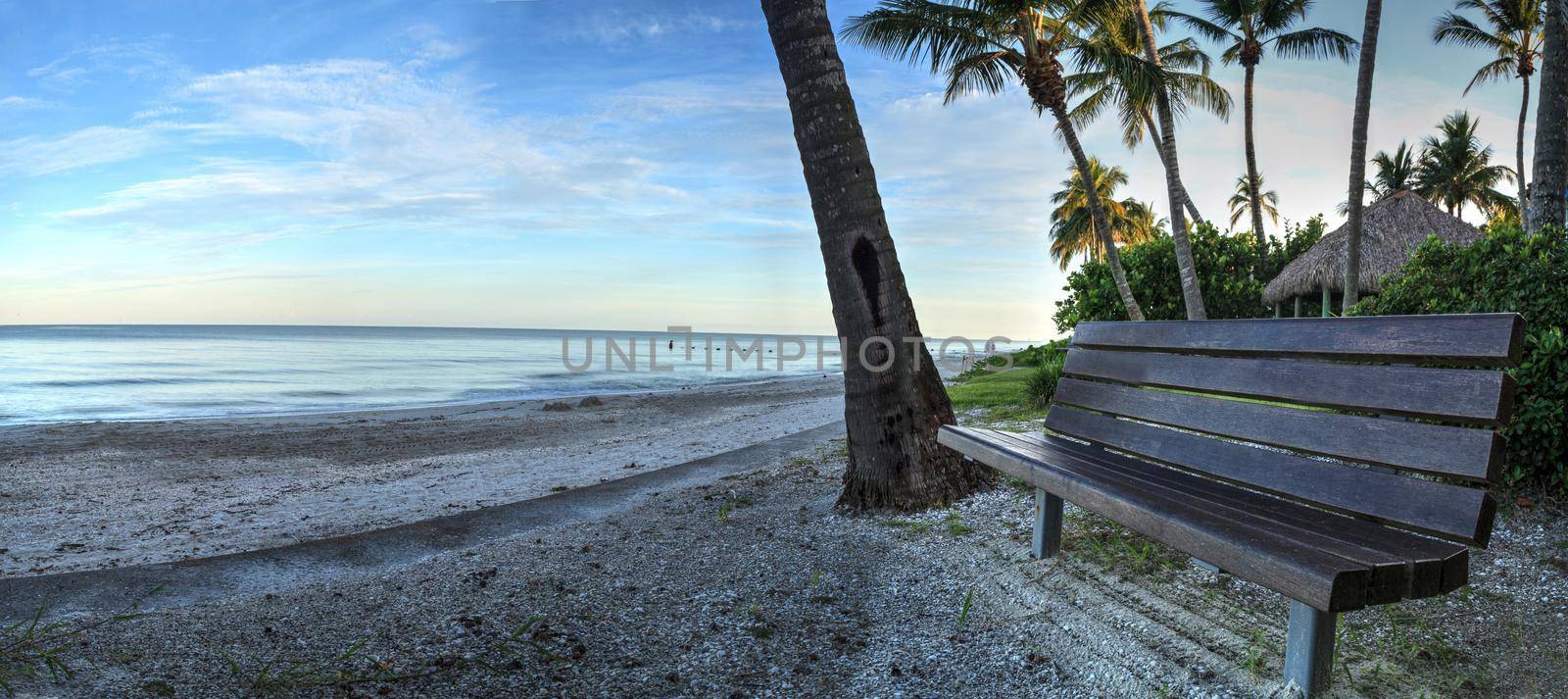 Bench overlooking the ocean at Port Royal Beach in Naples, Florida at sunrise.