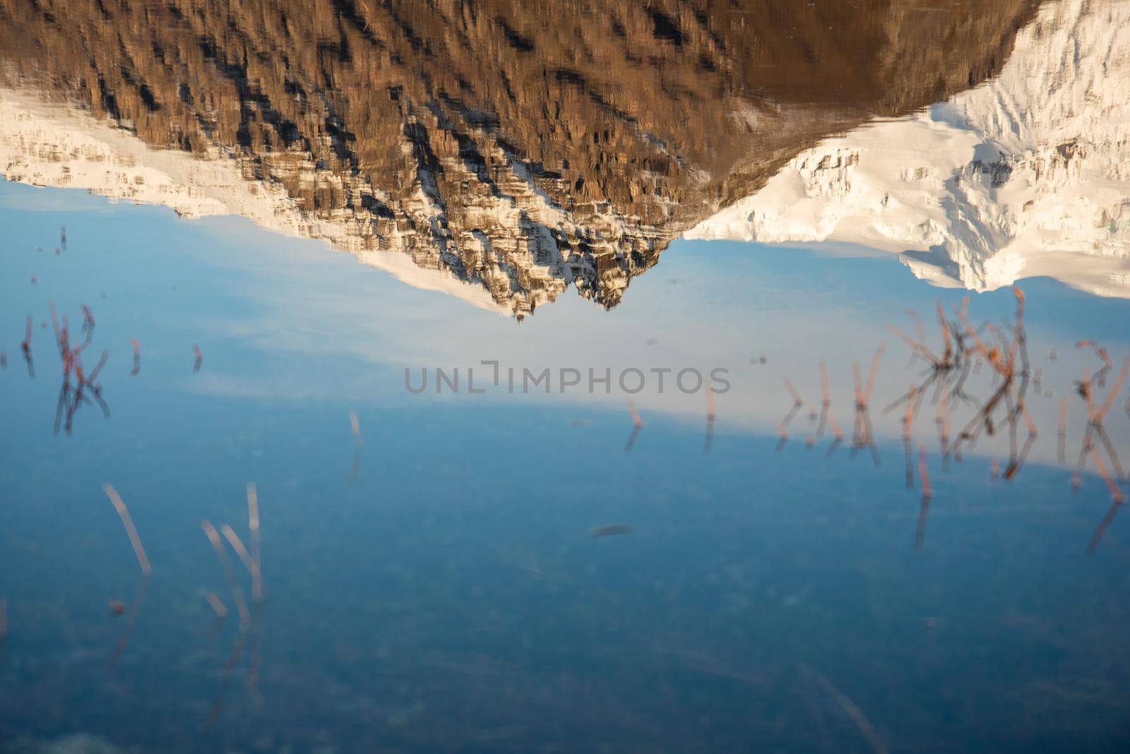 Reflection of Icelandic mountain range with beautiful snowcapped mountains by jyurinko