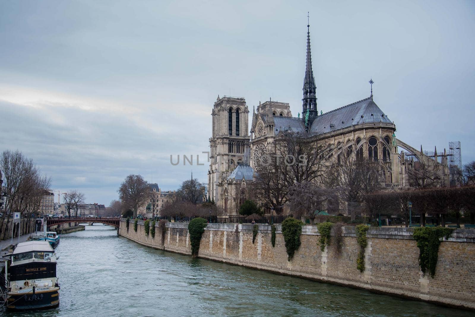 Paris, France - February 3, 2017: View of River Siene with Notre Dame de Paris across the way. Unique perspective