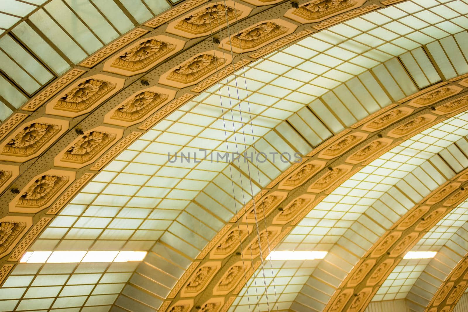 Paris, France - February 3, 2017: Detail photo of sage green and gold patterned arches inside of a Paris museum.