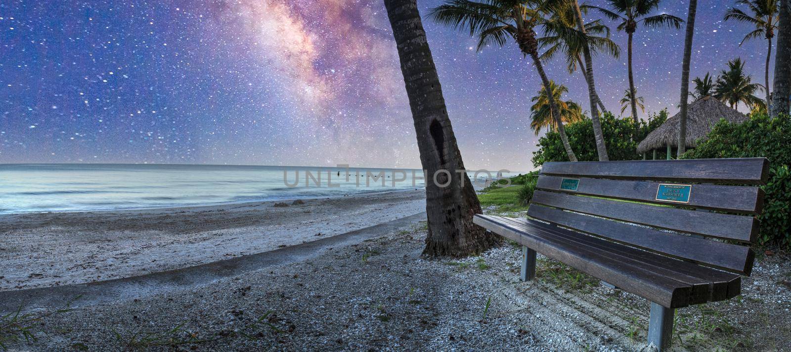 Milky way over Bench overlooking the ocean at Port Royal Beach in Naples, Florida at sunrise.